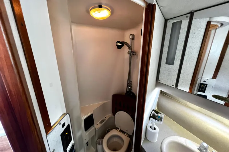 Slide: The Image of 1989 Cruisers Yachts 3670 Esprit bathroom with shower, toilet, and sink. - 23