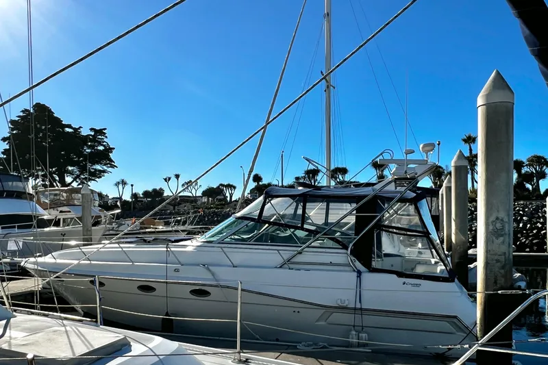 Slide: The Image of 1989 Cruisers Yachts 3670 Esprit docked at marina under clear blue sky. - 3