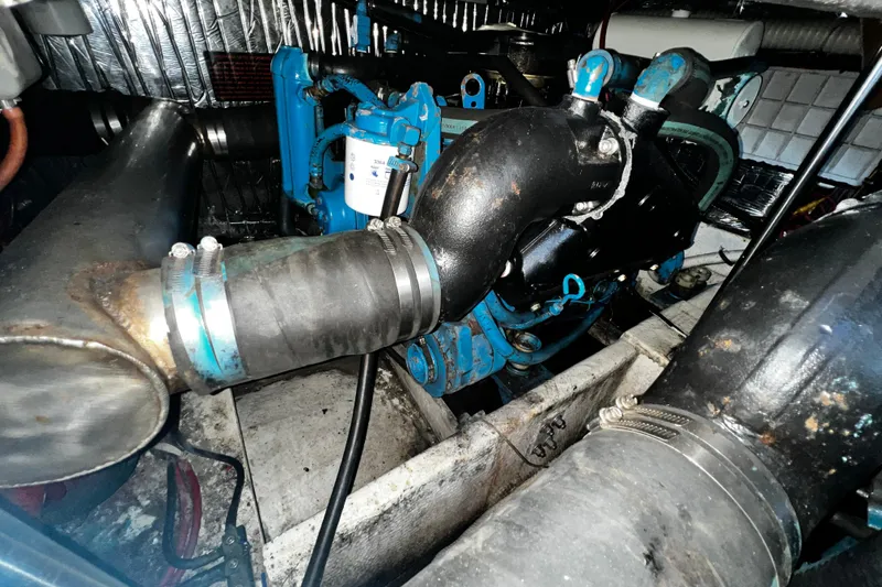 Slide: The Image of Engine compartment of 1989 Cruisers Yachts 3670 Esprit, showcasing mechanical components and piping. - 30