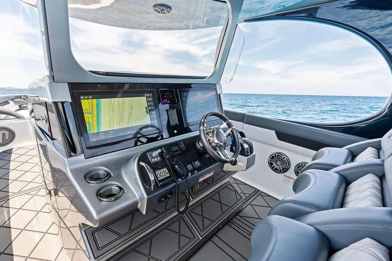 Slide: The Image of Luxurious Mystic M4200 boat cockpit with advanced navigation system, sleek design, and ocean view. - 26