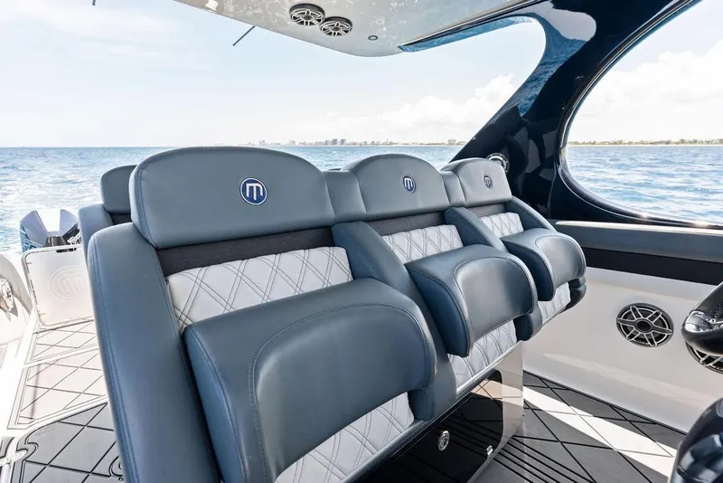 Slide: The Image of Luxury seating on a 2020 Mystic M4200 boat, overlooking the ocean. - 31
