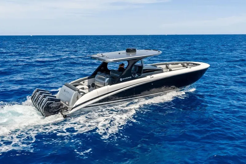 Slide: The Image of 2020 Mystic M4200 boat cruising on open blue ocean waters. - 13