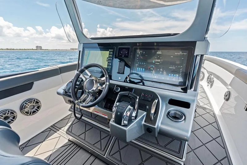 Slide: The Image of Helm of 2020 Mystic M4200 boat with advanced navigation system and ocean view. - 24