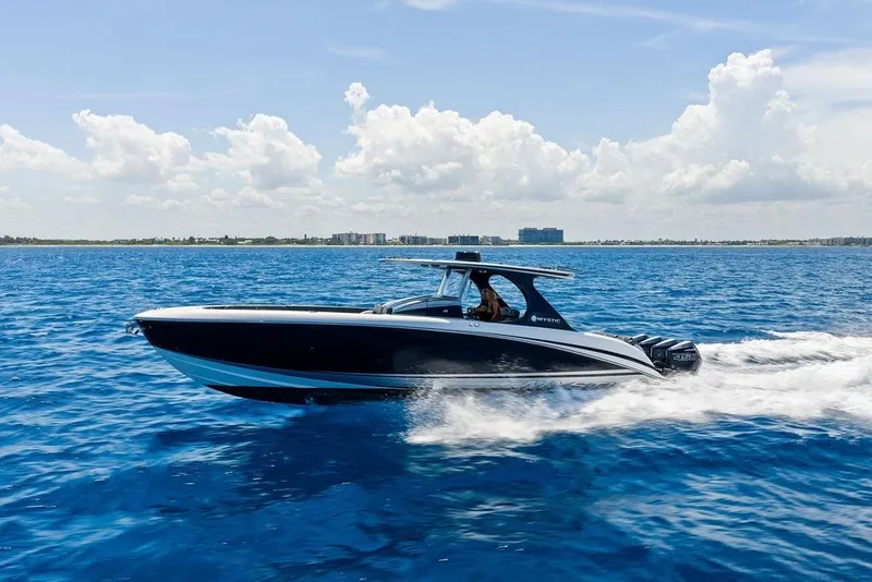 Slide: The Image of 2020 Mystic M4200 boat cruising on blue ocean under clear sky. - 5