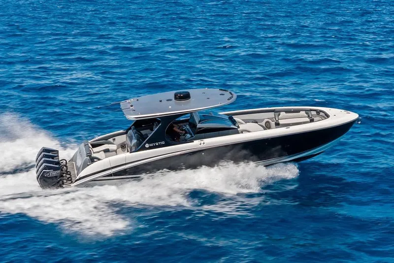 Slide: The Image of 2020 Mystic M4200 boat cruising on blue ocean waters. - 12