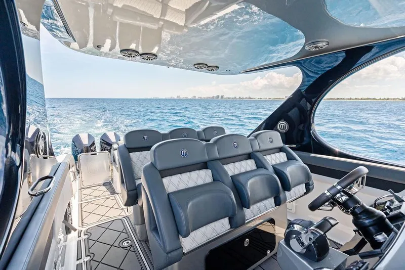 Slide: The Image of Luxurious 2020 Mystic M4200 boat interior with plush seating and ocean view. - 28