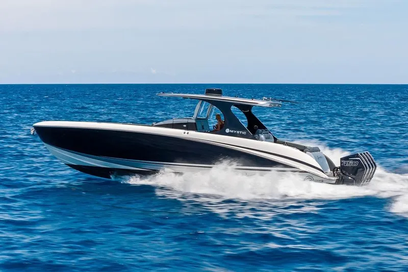 Slide: The Image of 2020 Mystic M4200 boat cruising on open blue ocean waters. - 6