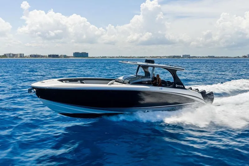 Slide: The Image of 2020 Mystic M4200 boat cruising on blue ocean under clear sky. - 7