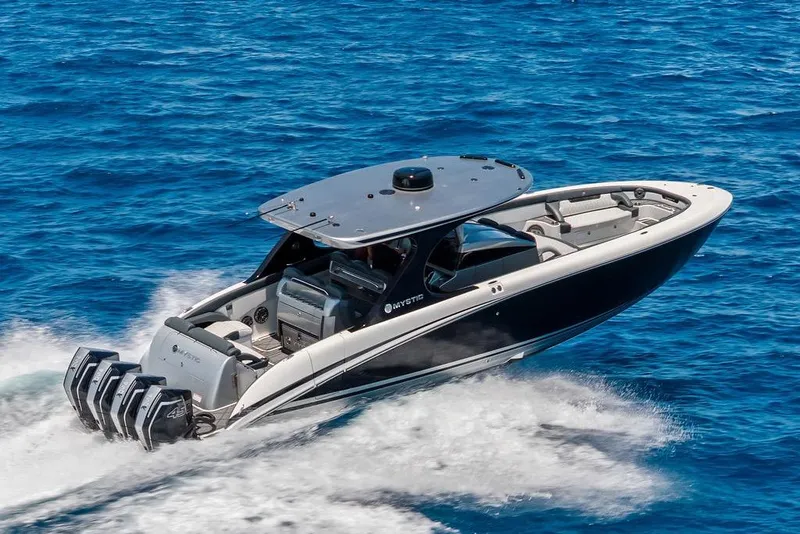 Slide: The Image of 2020 Mystic M4200 boat cruising on open blue ocean waters. - 2