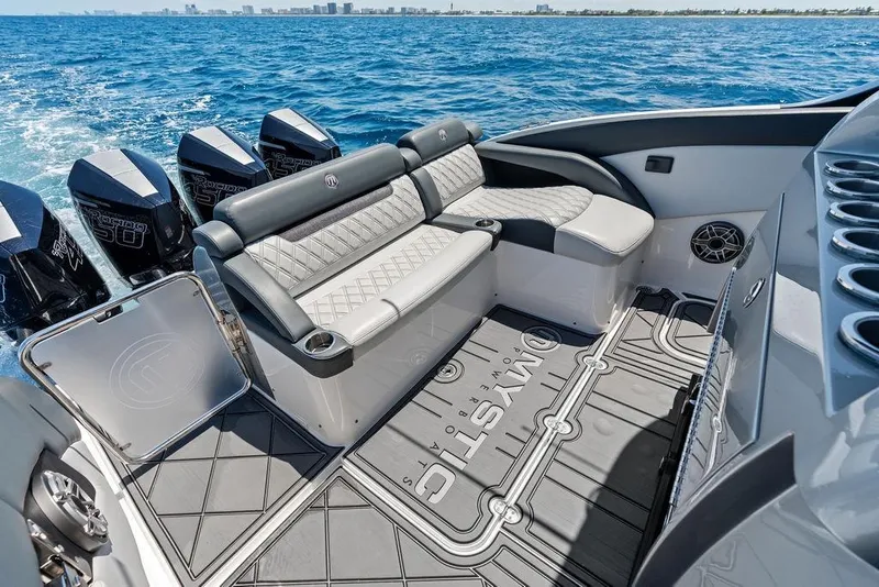 Slide: The Image of Luxury seating on a 2020 Mystic M4200 boat with powerful outboard engines. - 33