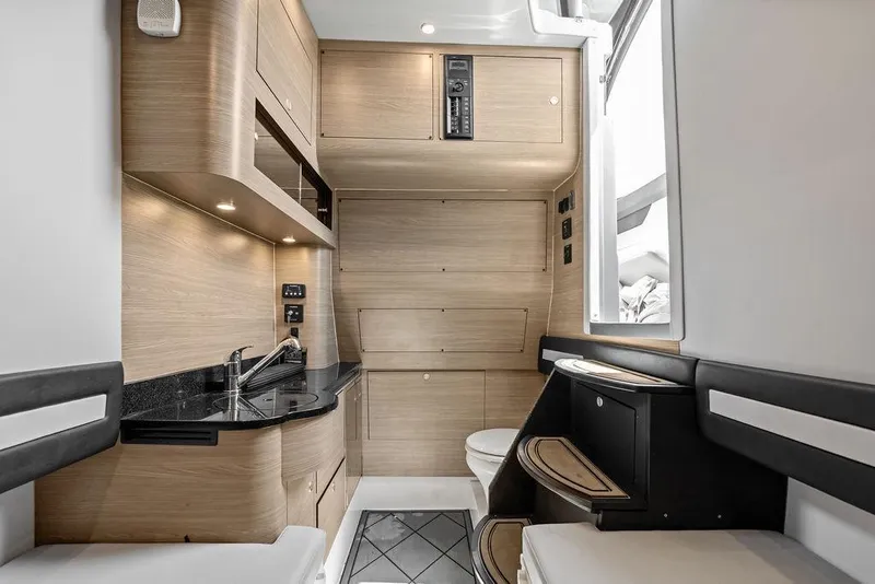Slide: The Image of Modern interior of a 2020 Mystic M4200 yacht featuring sleek wood cabinetry and compact amenities. - 39