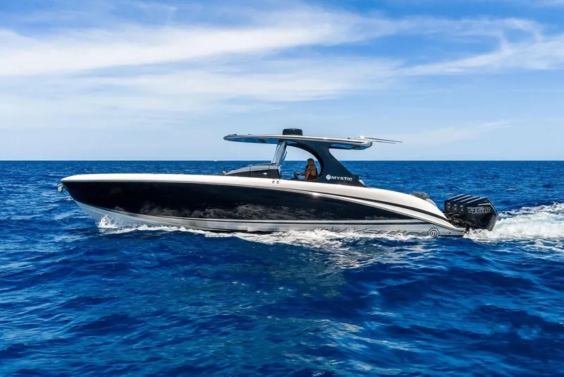 Slide: The Image of 2020 Mystic M4200 boat cruising on open blue ocean under clear sky. - 8