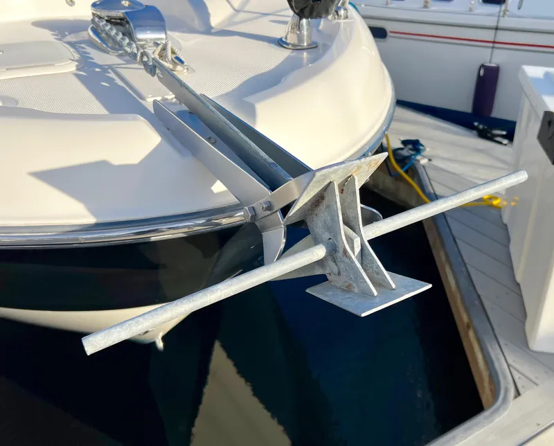 Slide: The Image of 2008 Bayliner 320 boat docked at marina, surrounded by modern buildings and clear blue sky. - 11