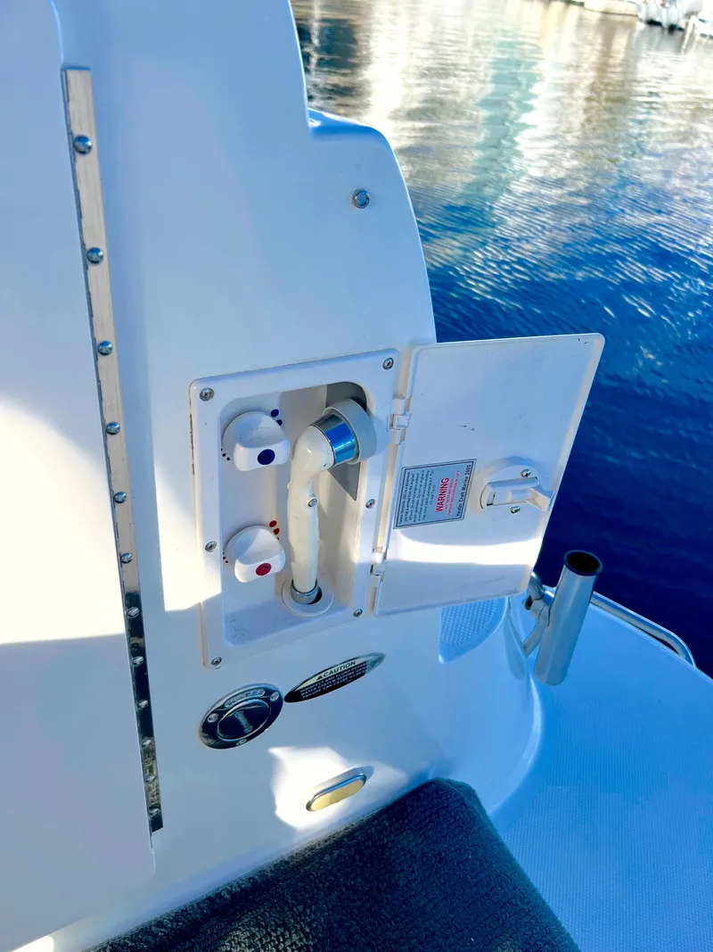 Slide: The Image of 2008 Bayliner 320 boat docked in marina under clear blue sky. - 15