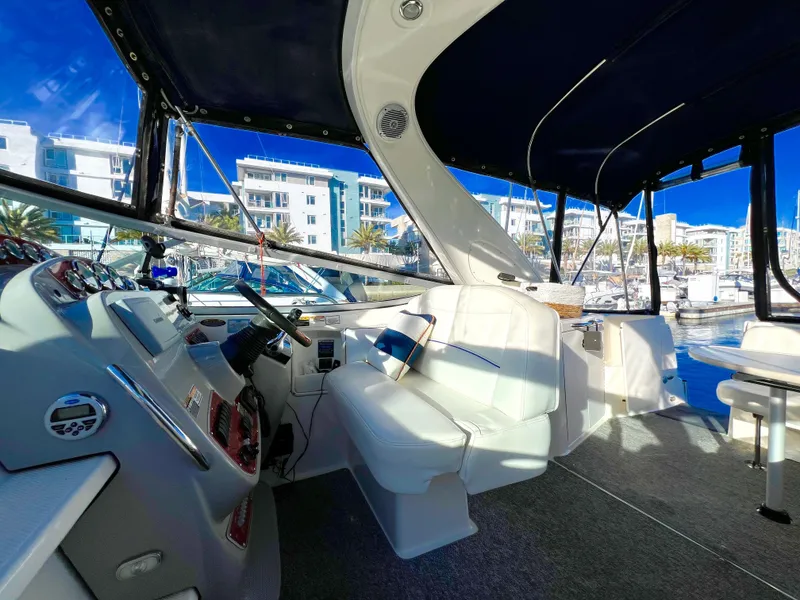 Slide: The Image of Interior view of a 2008 Bayliner 320 boat with white seating and cabinetry. - 19