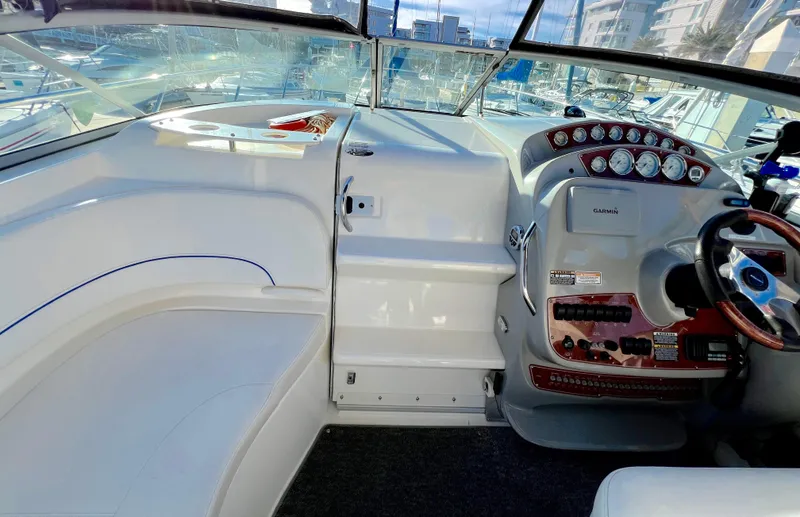 Slide: The Image of 2008 Bayliner 320 boat interior with marina view, featuring sink and safety equipment. - 20