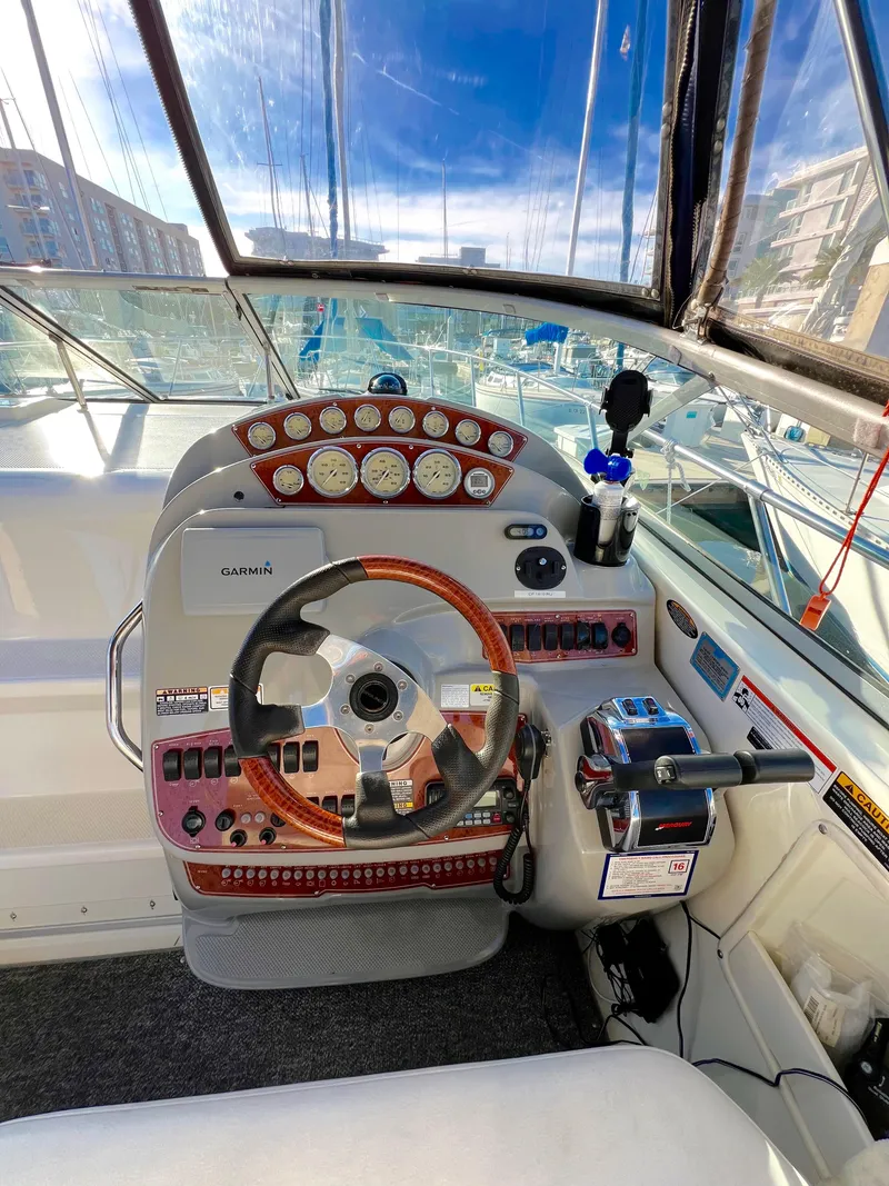 Slide: The Image of 2008 Bayliner 320 boat interior with modern helm, seating, and marina view. - 21