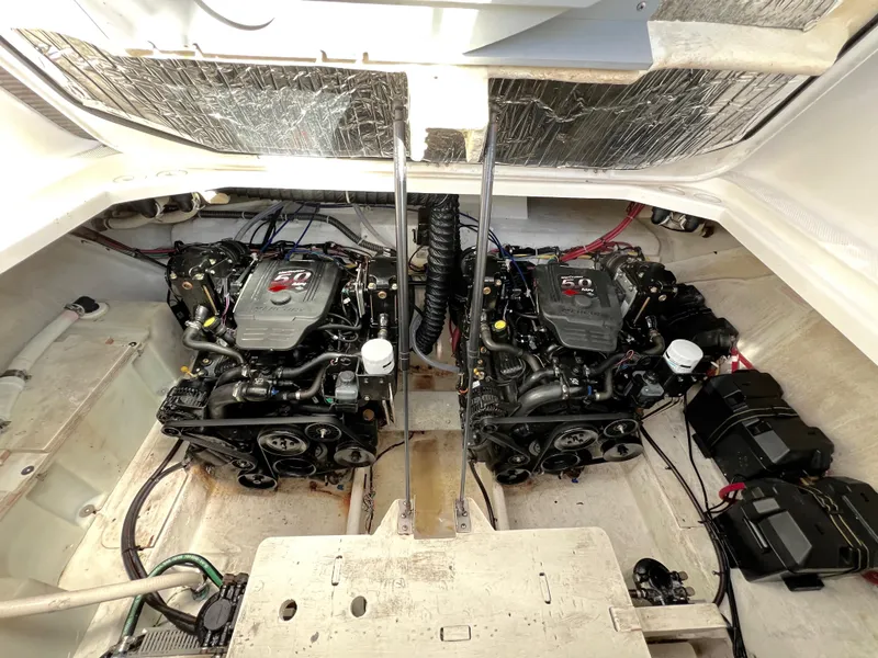 Slide: The Image of 2008 Bayliner 320 interior storage compartment with various items, including a cooler and boxes. - 28