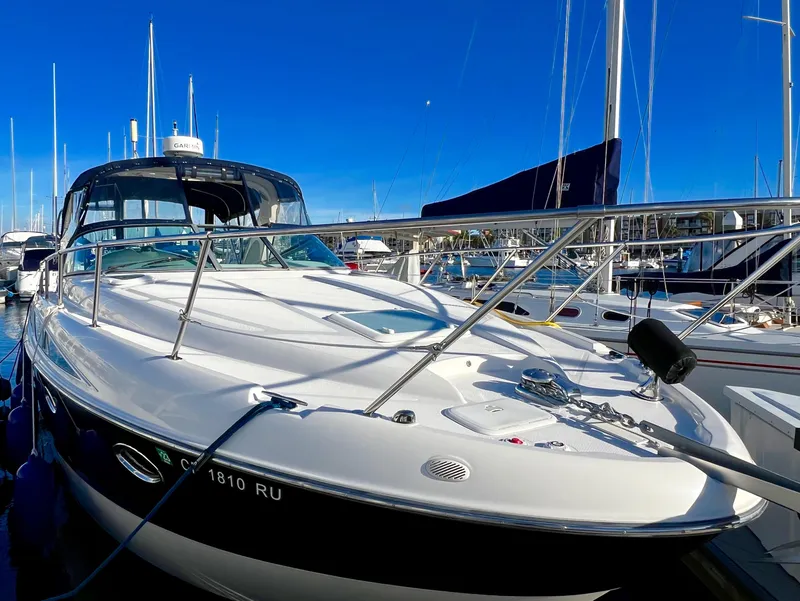 Slide: The Image of 2008 Bayliner 320 boat docked at a marina under clear blue skies. - 3