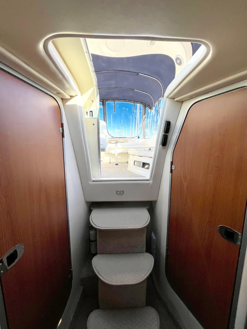 Slide: The Image of Luxurious cabin interior of 2008 Bayliner 320 with nautical-themed bedding. - 36