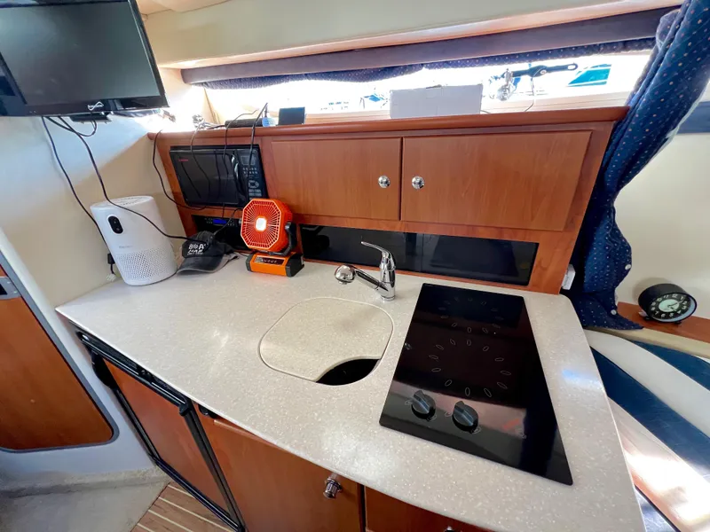 Slide: The Image of 2008 Bayliner 320 interior with cozy seating and wooden table. - 37