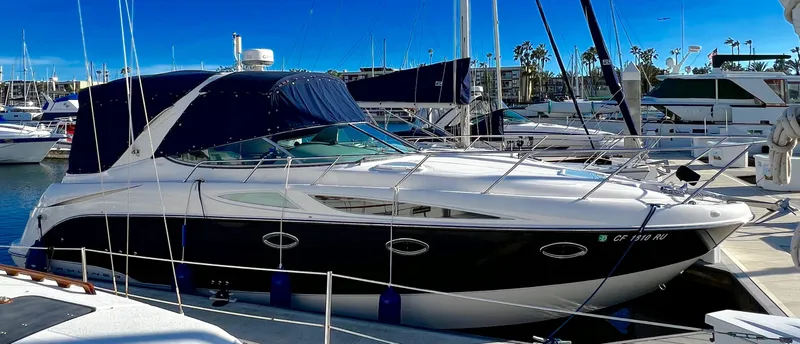 Slide: The Image of 2008 Bayliner 320 yacht docked at marina under clear blue sky. - 4