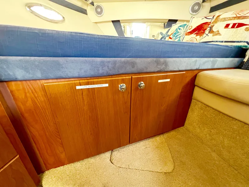 Slide: The Image of Interior of a 2008 Bayliner 320 boat showing kitchen cabinets and stove. - 42