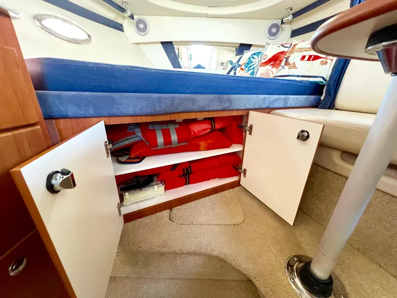 Slide: The Image of 2008 Bayliner 320 kitchen with open cabinets and drawers, showcasing storage and organization. - 43