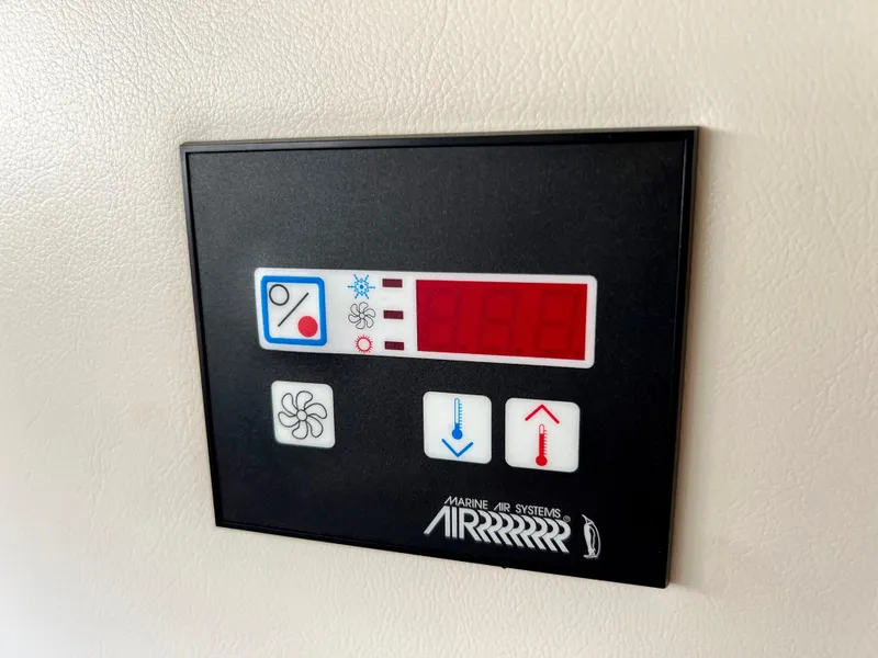 Slide: The Image of Interior of 2008 Bayliner 320 boat with wooden cabinets and blue cushioned seating. - 44