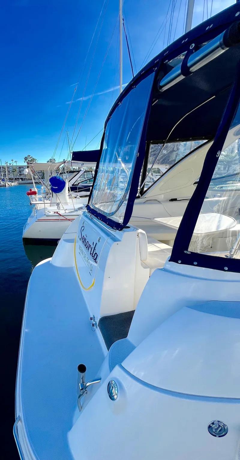 Slide: The Image of 2008 Bayliner 320 boat with blue LED lights docked at night. - 5