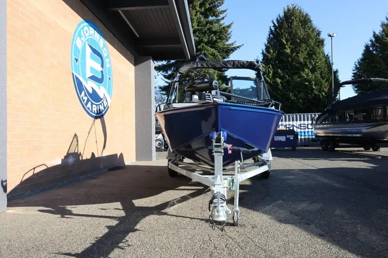 Slide: The Image of 2026 Lowe Fish & Ski 1625 boat on trailer at Bjornson Marine dealership. - 12