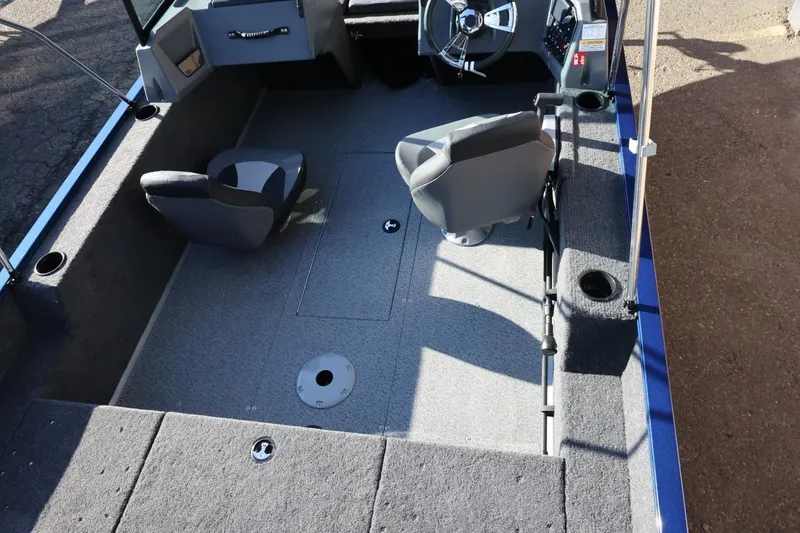 Slide: The Image of 2026 Lowe Fish & Ski 1625 boat interior with seating and steering wheel. - 17