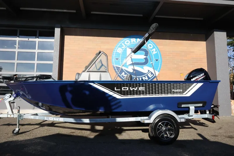 Slide: The Image of 2026 Lowe Fish & Ski 1625 boat on trailer, displayed outdoors. - 2