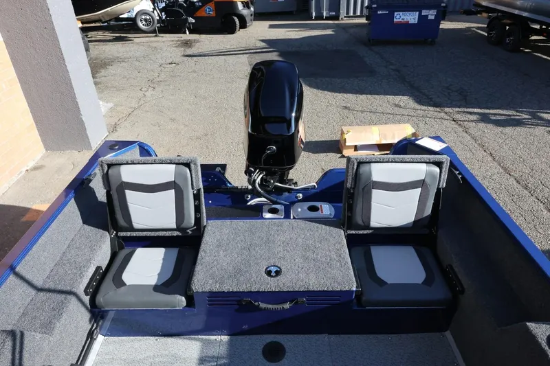 Slide: The Image of 2026 Lowe Fish & Ski 1625 boat interior with seating and motor. - 21