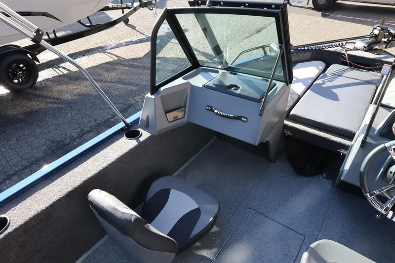Slide: The Image of 2026 Lowe Fish & Ski 1625 boat interior with seating and windshield. - 25