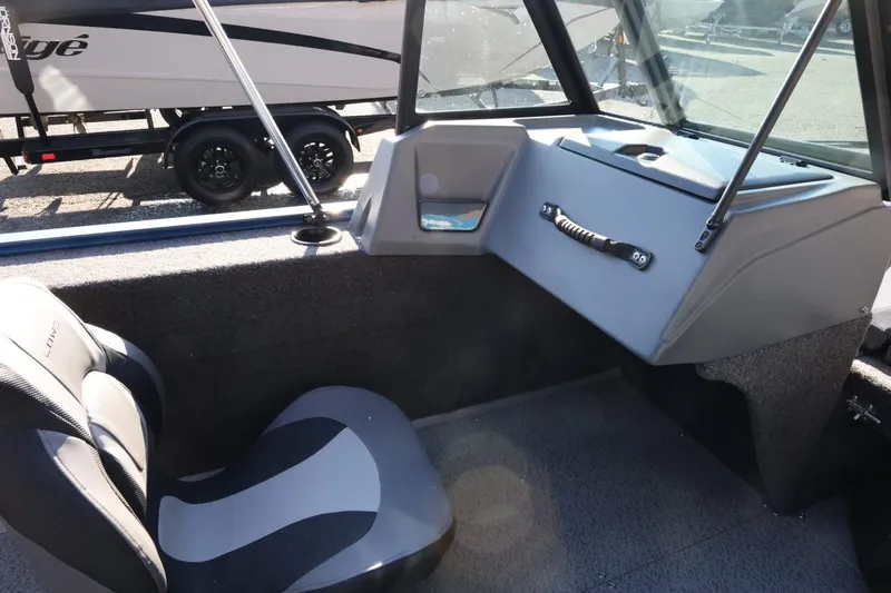 Slide: The Image of Interior of 2026 Lowe Fish & Ski 1625 boat with seating and dashboard. - 29