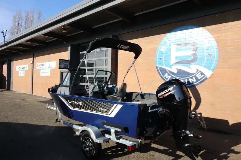 Slide: The Image of 2026 Lowe Fish & Ski 1625 boat with Mercury engine outside dealership. - 3