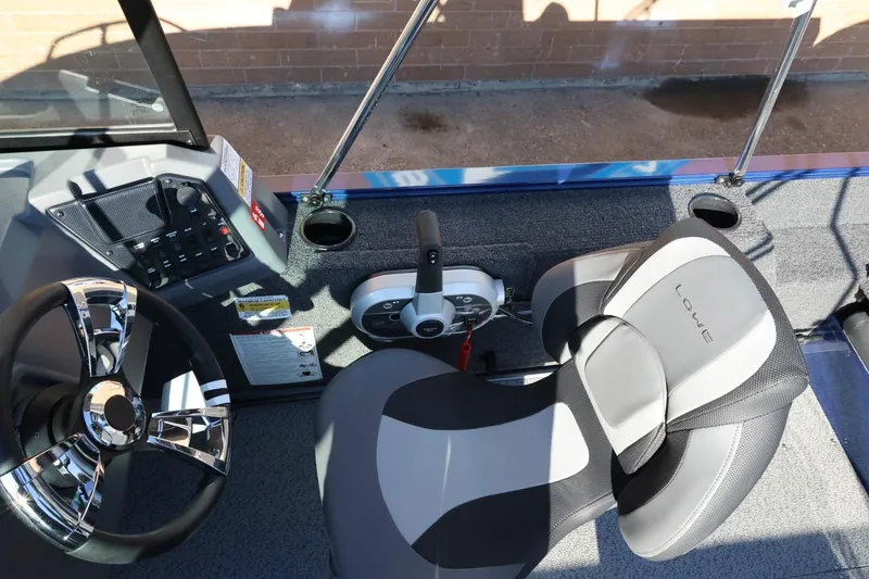 Slide: The Image of Interior of 2026 Lowe Fish & Ski 1625 boat with steering wheel and seat. - 31