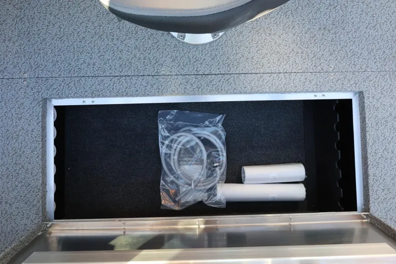 Slide: The Image of Storage compartment in 2026 Lowe Fish & Ski 1625 boat with accessories. - 32