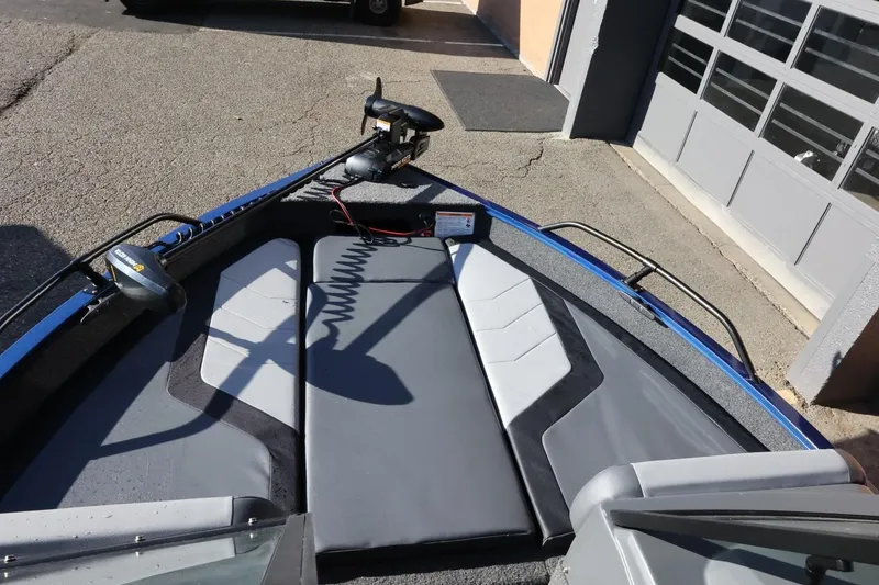 Slide: The Image of 2026 Lowe Fish & Ski 1625 boat interior with seating and trolling motor. - 33