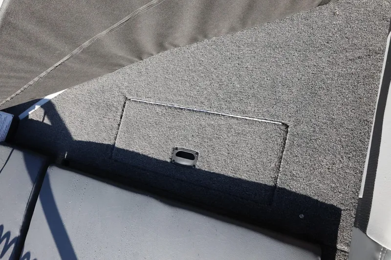 Slide: The Image of 2026 Lowe Fish & Ski 1625 boat interior with carpeted storage compartment. - 35