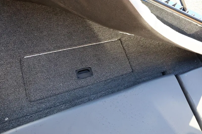 Slide: The Image of 2026 Lowe Fish & Ski 1625 boat interior storage compartment with carpeted finish. - 37