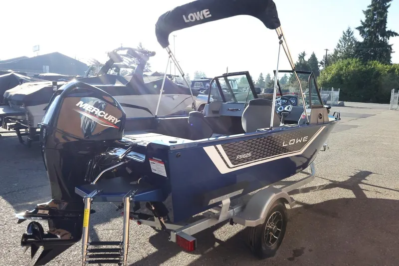 Slide: The Image of 2026 Lowe Fish & Ski 1625 boat with Mercury engine, parked outdoors. - 7