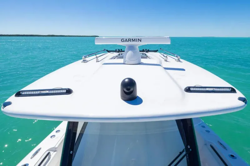 Slide: The Image of 2025 Blackwater 43 Luxury Fish boat on turquoise water, featuring Garmin equipment. - 15