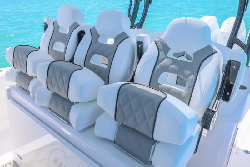 Slide: The Image of Luxury seating on 2025 Blackwater 43 Luxury Fish boat, featuring plush white and gray upholstery. - 23