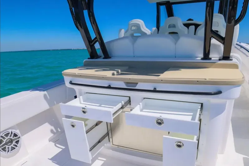 Slide: The Image of 2025 Blackwater 43 Luxury Fish boat interior with open storage drawers, ocean view. - 33