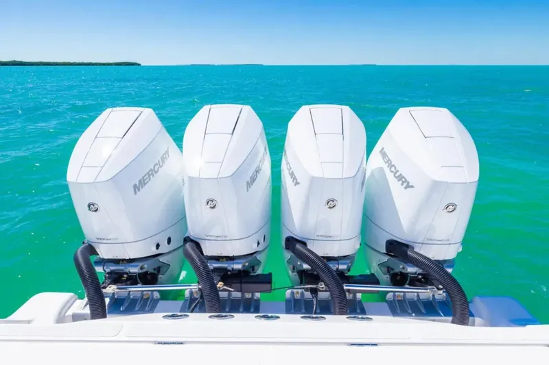 Slide: The Image of Four Mercury outboard engines on a 2025 Blackwater 43 Luxury Fish boat in turquoise waters. - 39