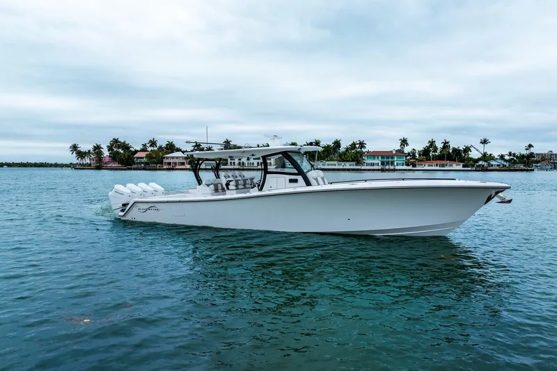 Slide: The Image of 2026 Blackwater 43 Luxury Fish boat on calm water, with coastal homes in the background. - 67