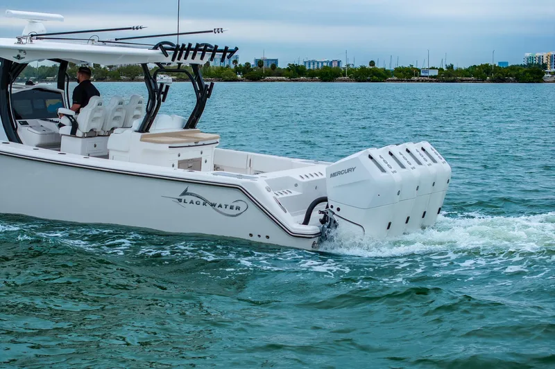Slide: The Image of 2026 Blackwater 43 Luxury Fish boat cruising on water with multiple Mercury engines. - 84