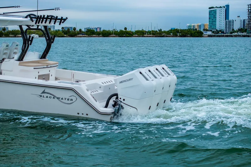 Slide: The Image of Luxury Blackwater 43 boat cruising with powerful Mercury engines on a serene waterway. - 89